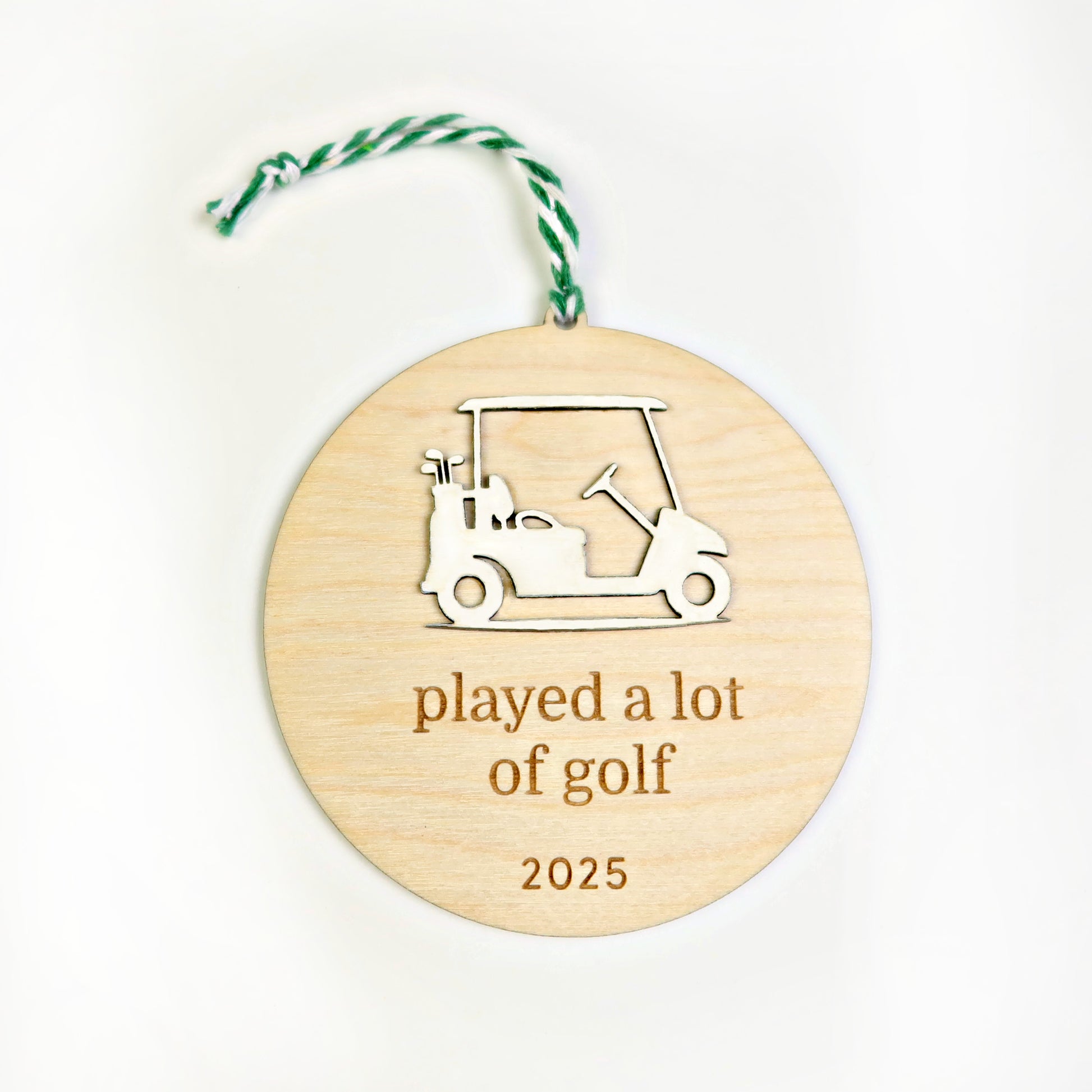 Wooden ornament with golf cart design and 'played a lot of golf 2025' text on a white background