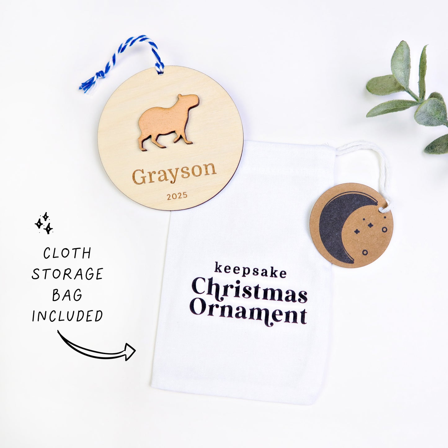 Wood Engraved Capybara Personalized Kids Name Christmas Ornament 2025 or Unique Christmas stocking tag for kids handmade by Moon Rock Prints includes cloth keepsake ornament storage bag