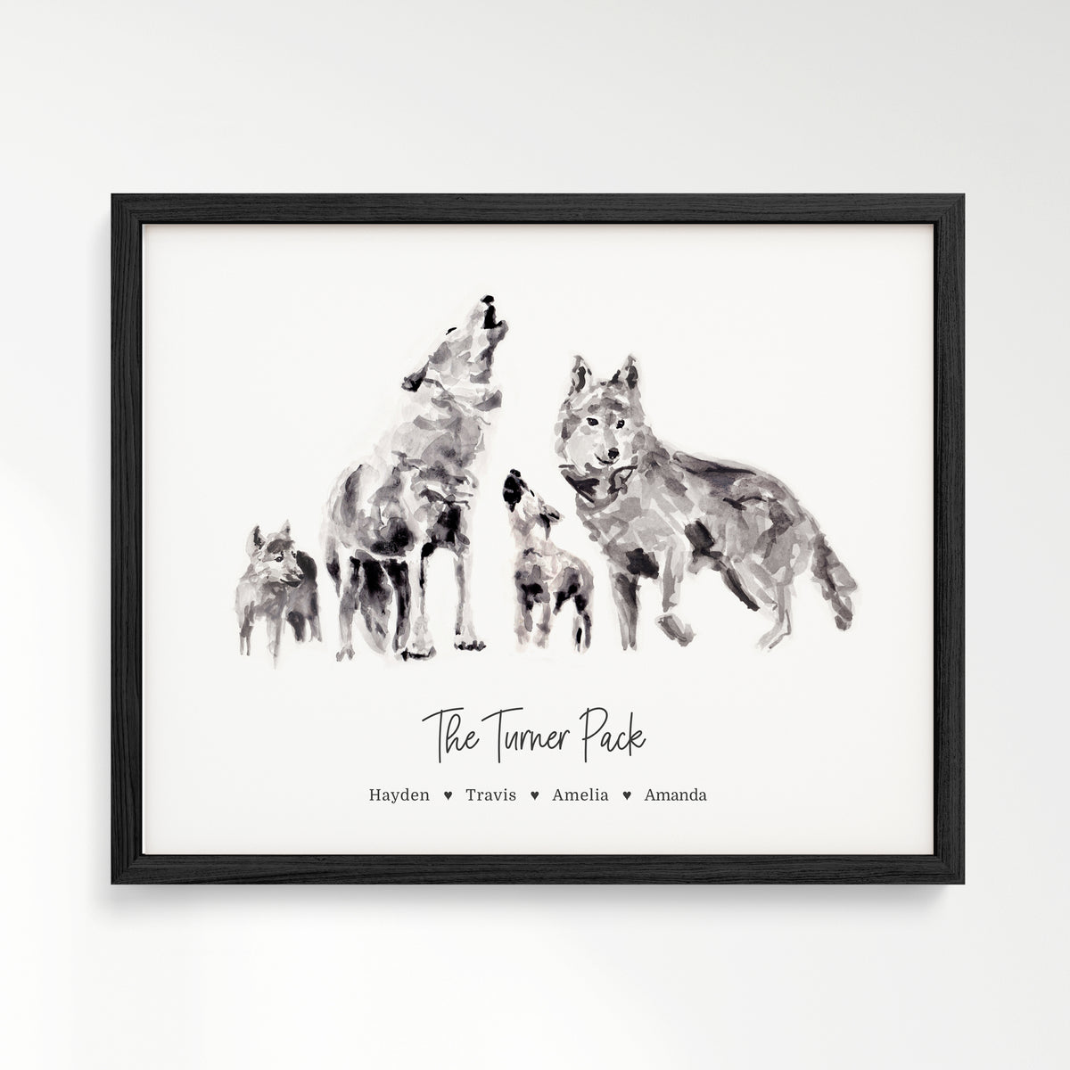 Personalized Wolf Family of 4 Watercolor Art Print framed in a black wood frame by Moon Rock Prints