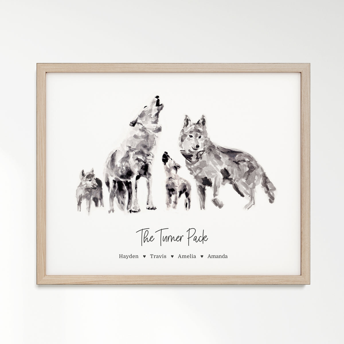 Personalized Wolf Family of 4 Watercolor Art Print framed in a light oak wood frame by Moon Rock Prints