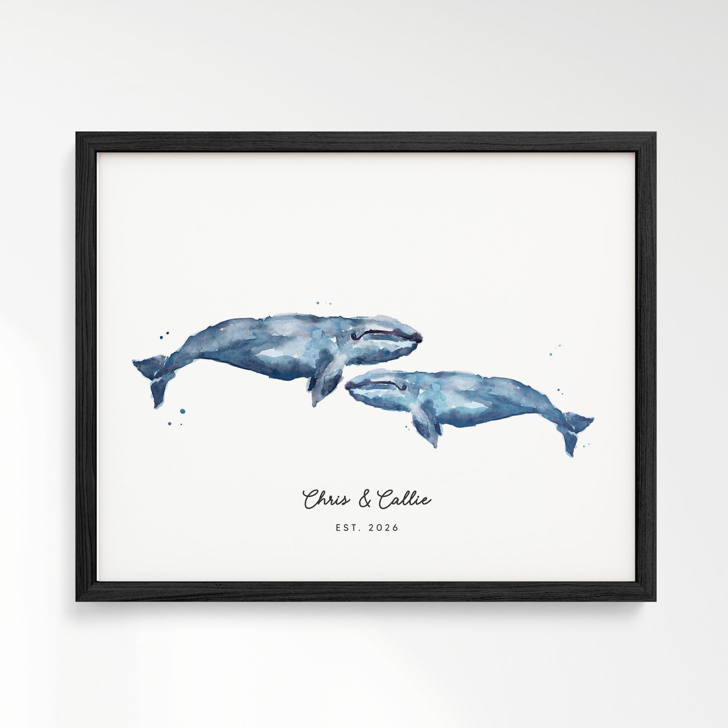 Framed artwork of two blue whales on a white background in black frame