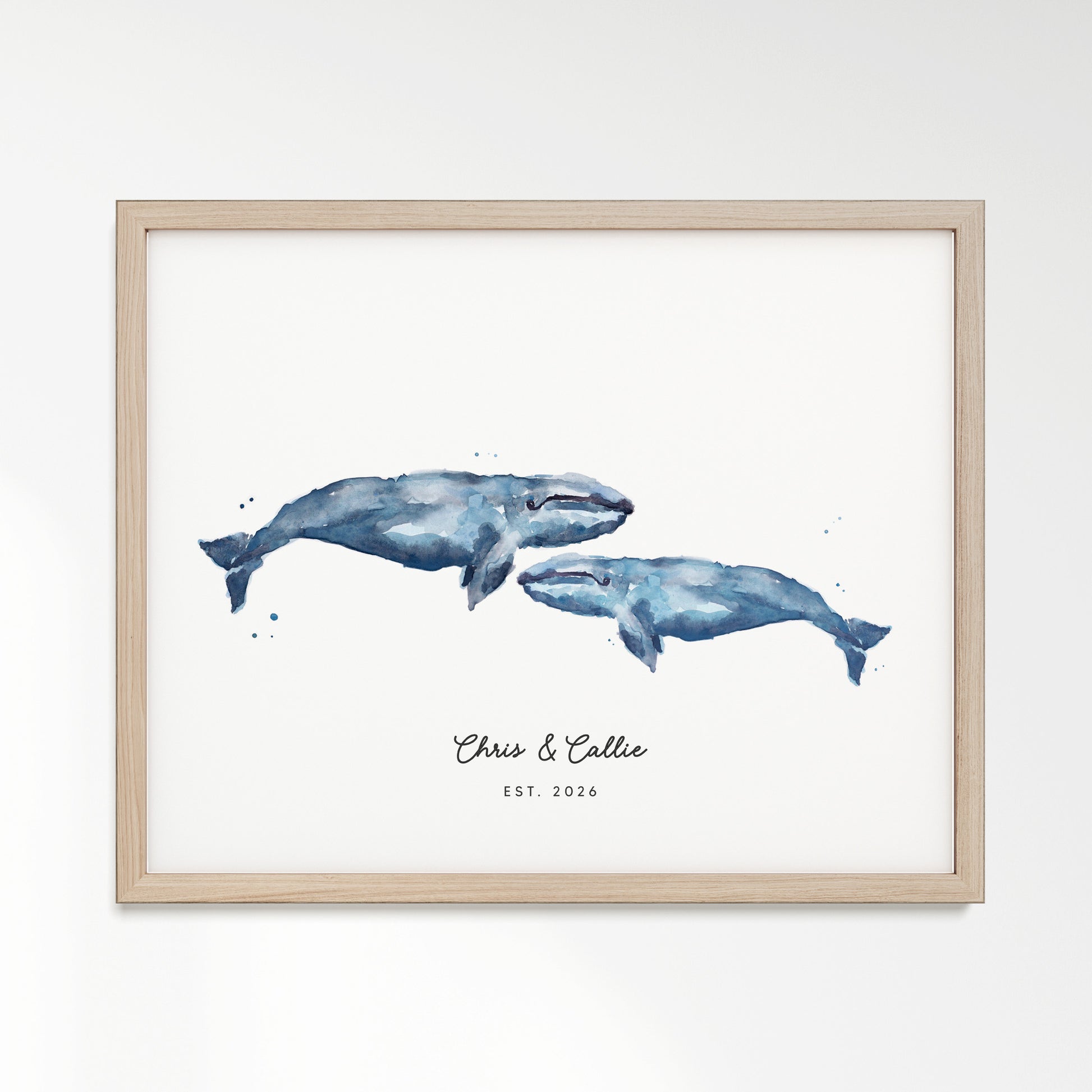 Framed artwork of two blue whales with 'Chris & Callie Est. 2020' text on a white background with Natural Oak Frame