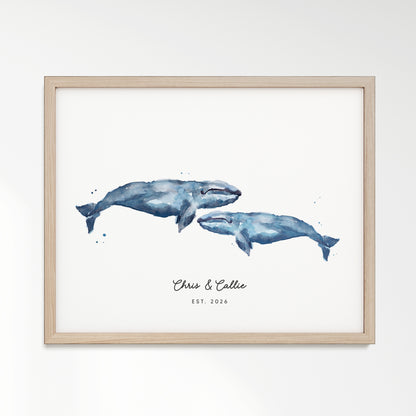 Framed artwork of two blue whales with 'Chris & Callie Est. 2020' text on a white background with Natural Oak Frame