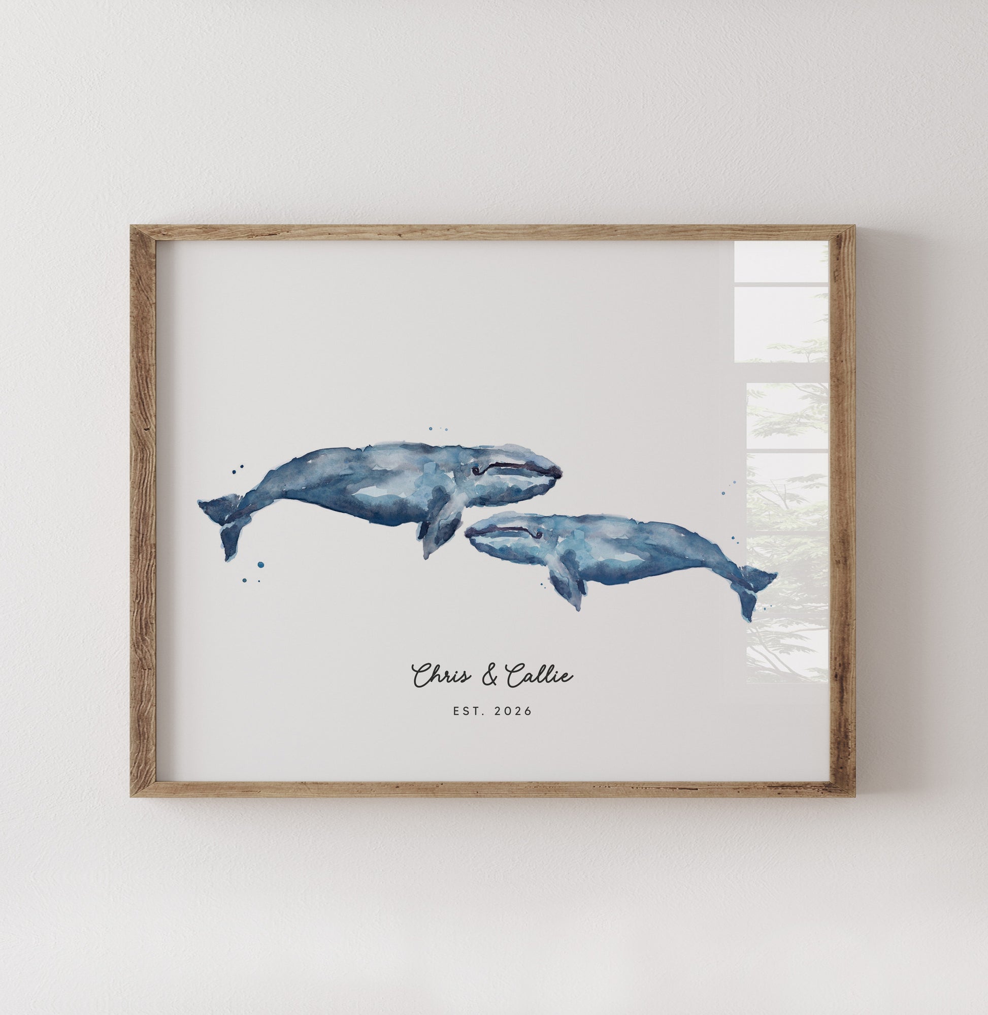 Framed artwork of two whales on a white background